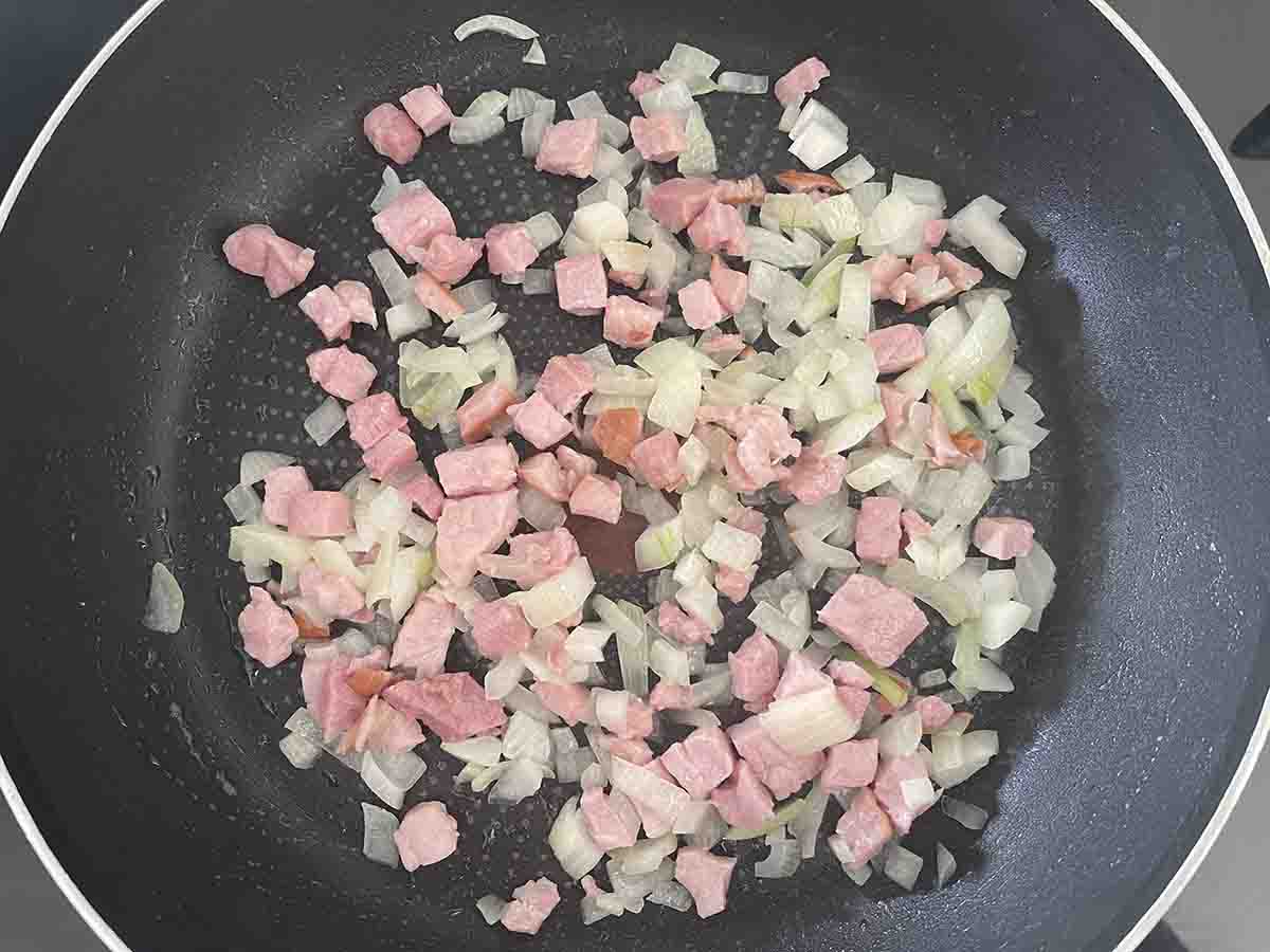 onion and bacon in a pan.