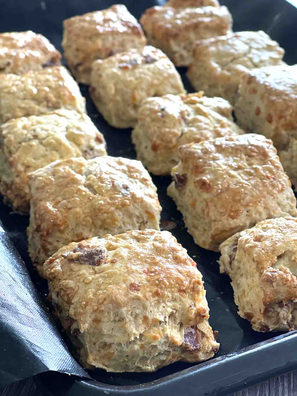 cooked bacon scones on a baking sheet.