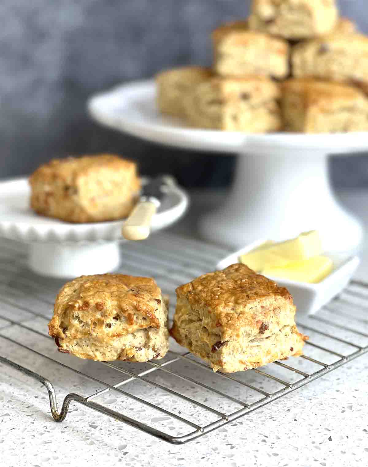  scones on a stand and 2 on a cooling rack.