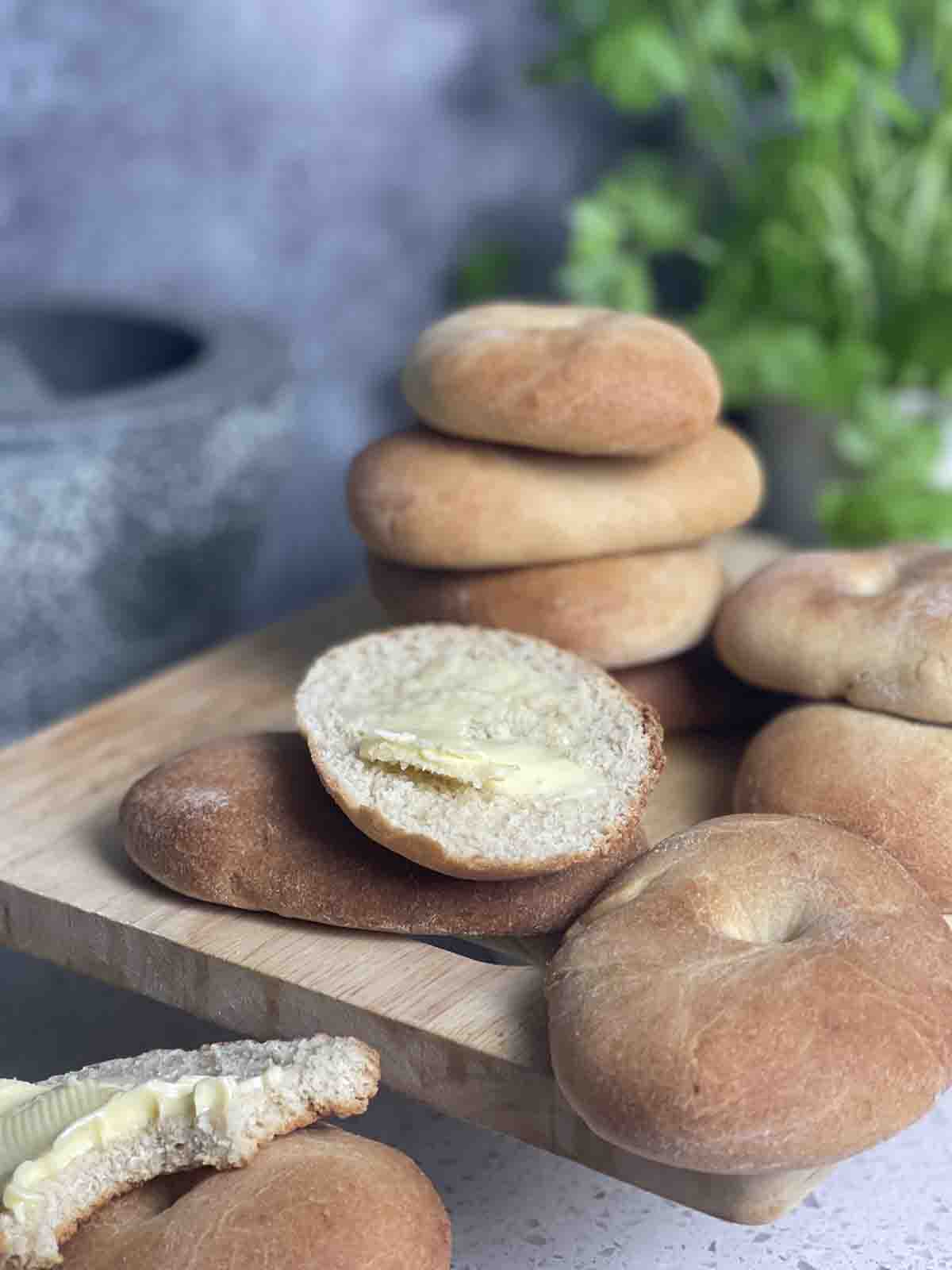 bread rolls in stacks with a sliced roll.