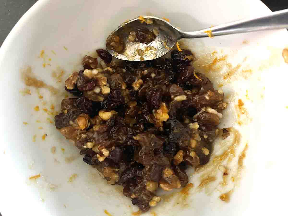 mincemeat in a bowl mixed with walnuts and cranberries.