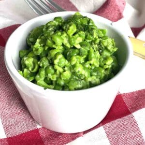 portion of minted mushy peas in a white dish.
