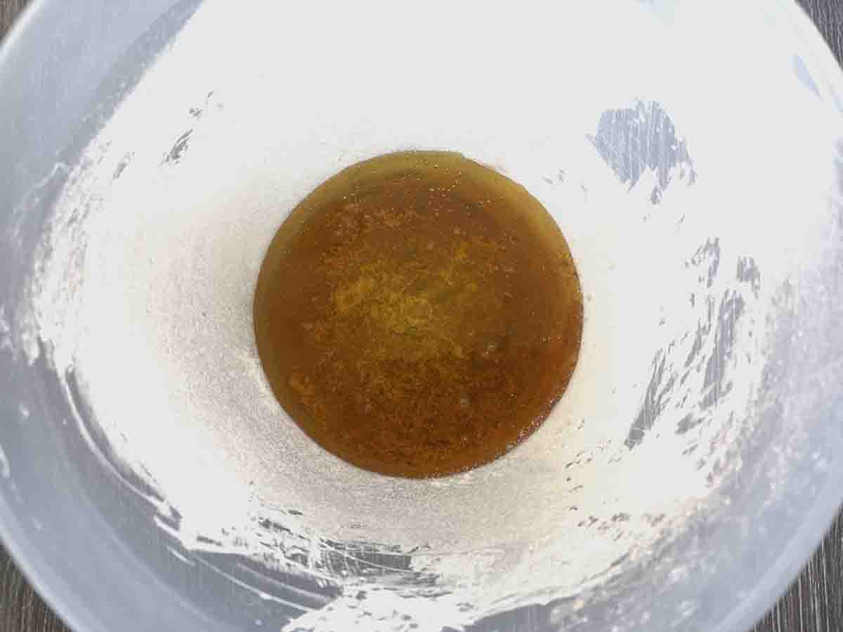 plastic bowl with golden syrup in the bottom.