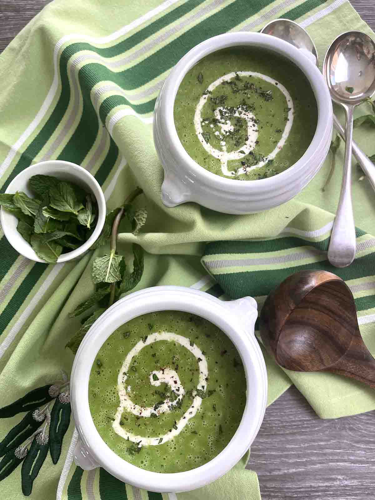 two bowls of soup and a green towel.