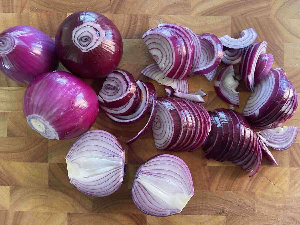 sliced onions on a board.