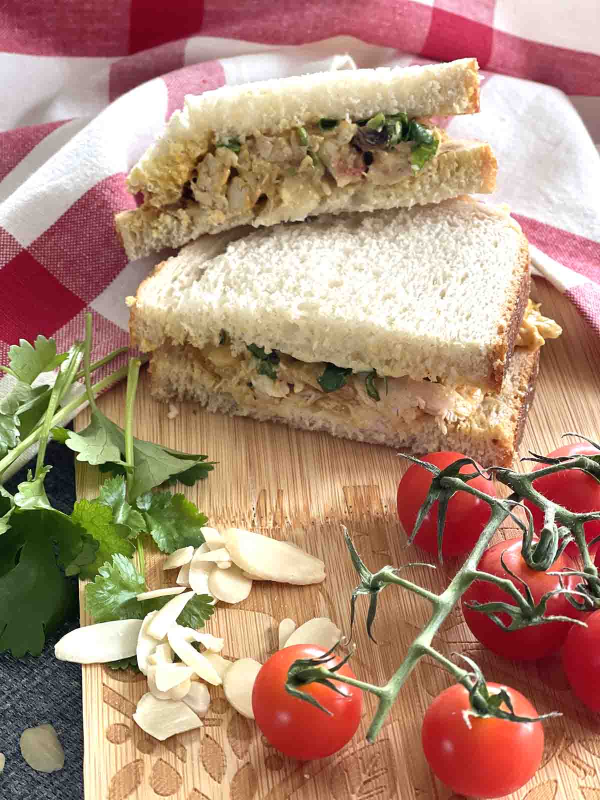 sandwich on a board with tomatoes to the front.