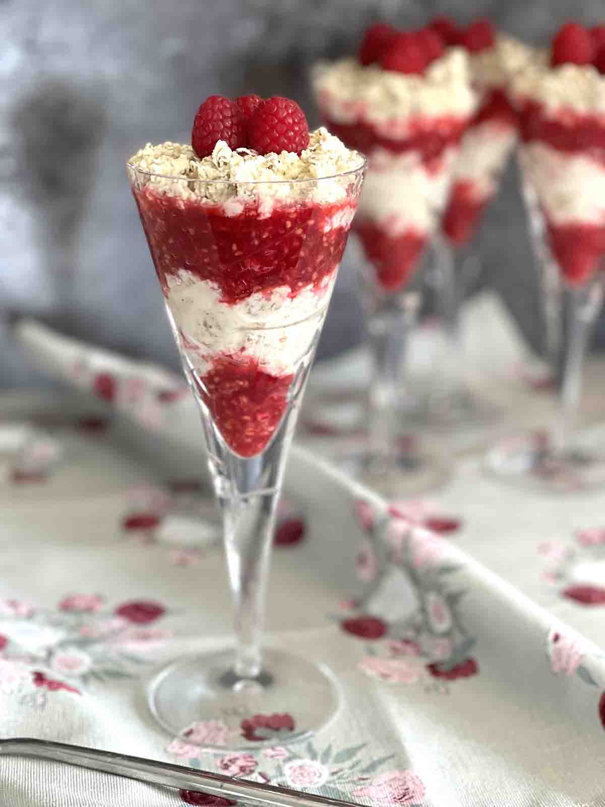 layered scottish cranachan raspberry desserts in glasses.