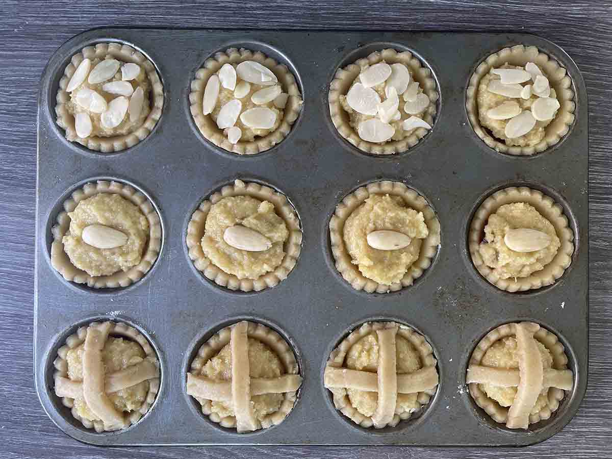 tarts decorated with almonds and pastry.