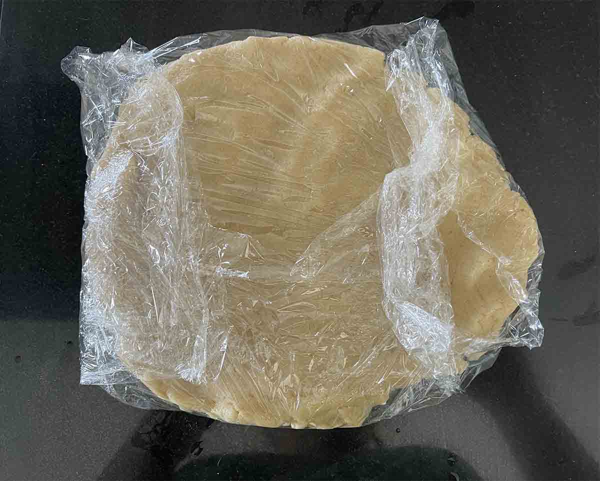 flattened pastry in cling film.