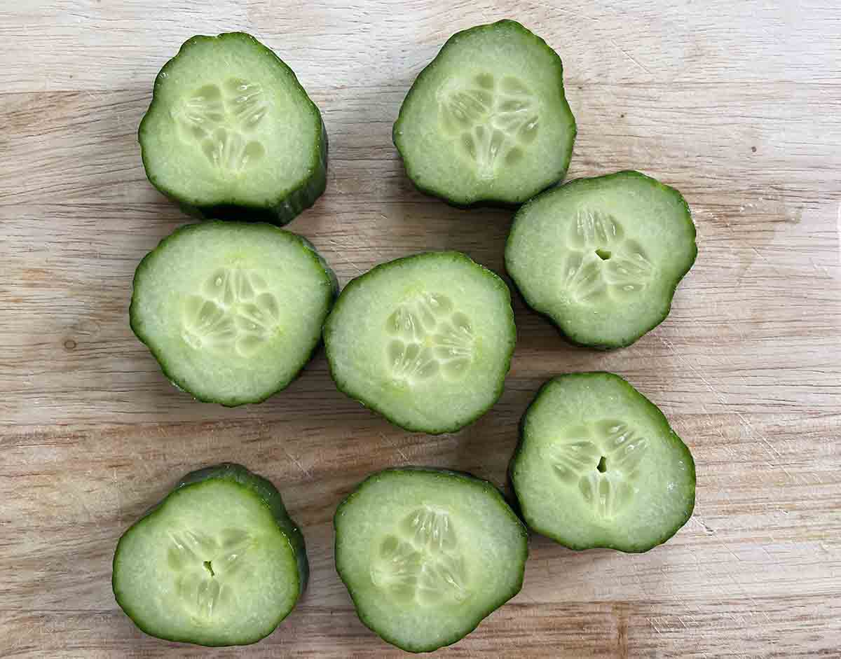 cucumber slices on a board.