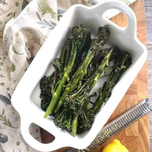roasted tenderstem broccoli in a white dish.