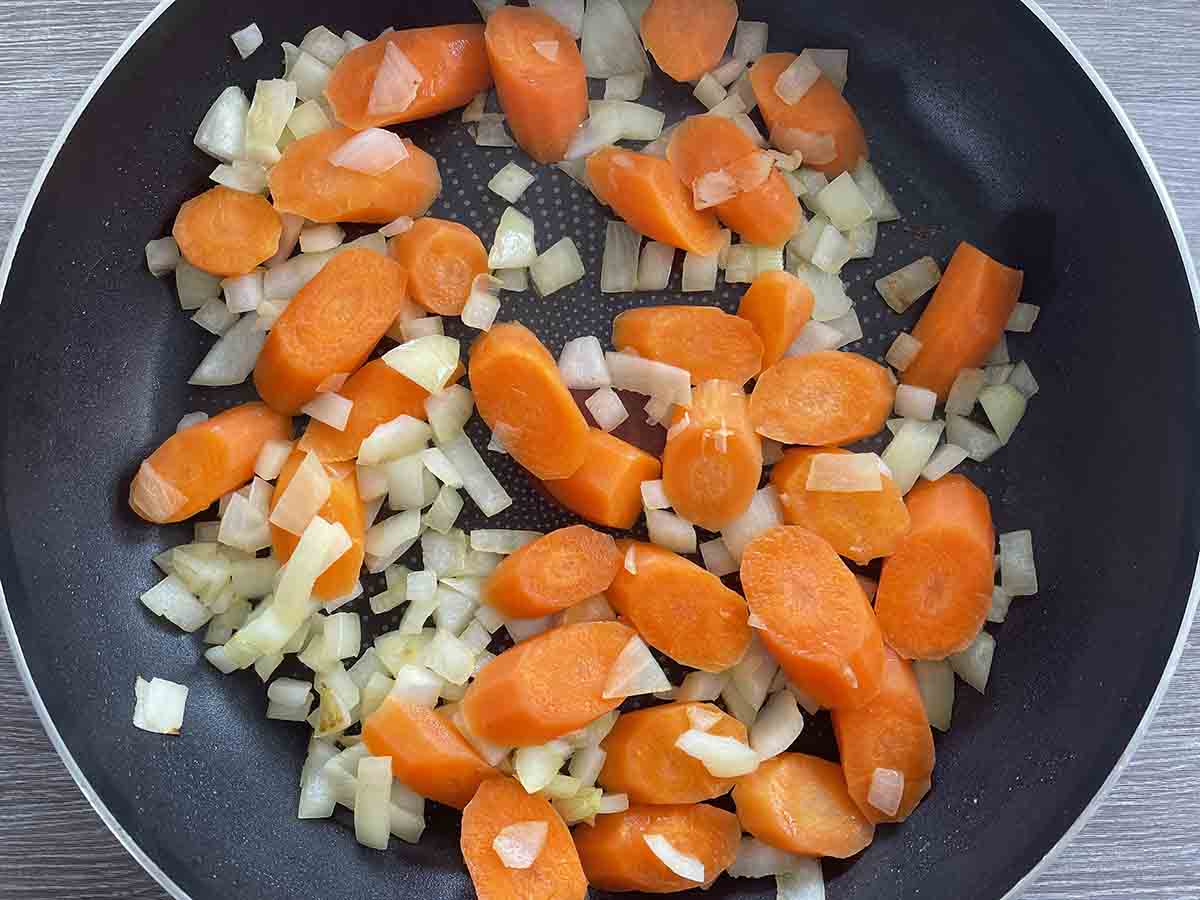 carrots and onions in a pan.