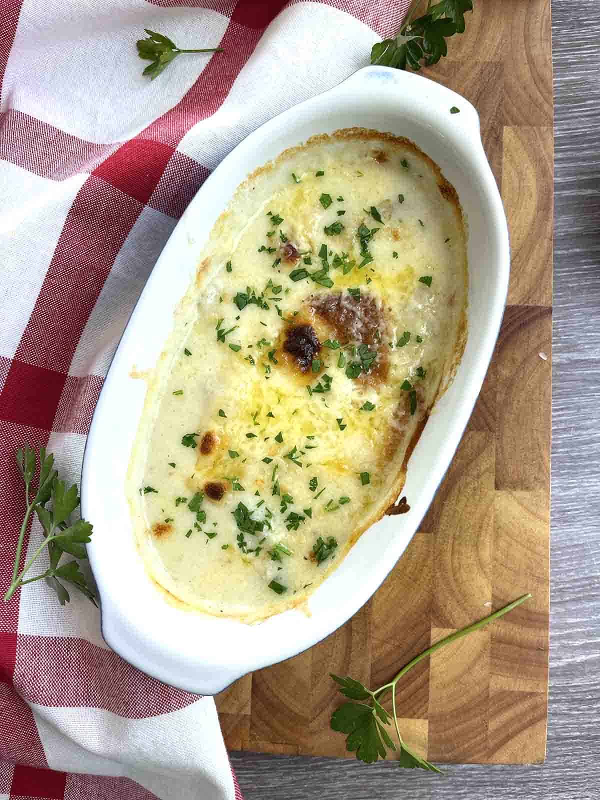 fish mornay in a dish.