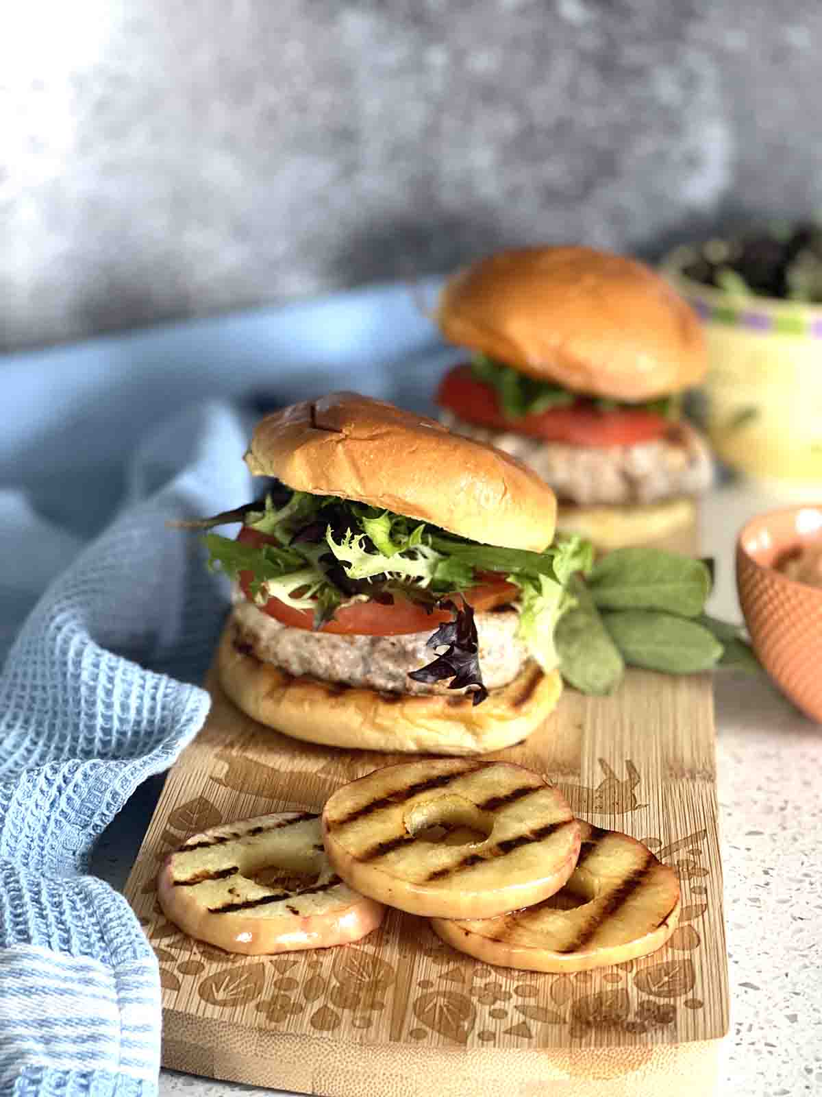 pork burger with apple in front.