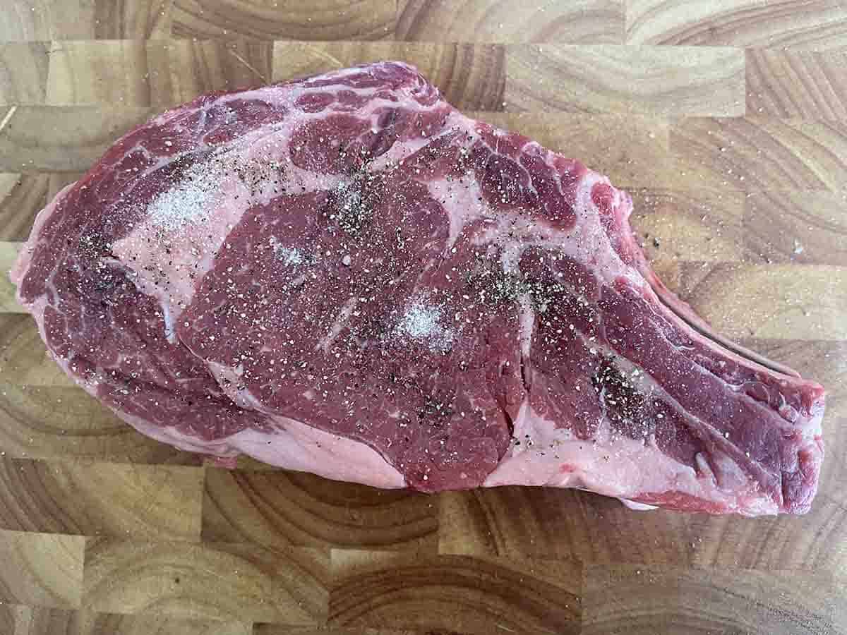 seasoned steak on a board.
