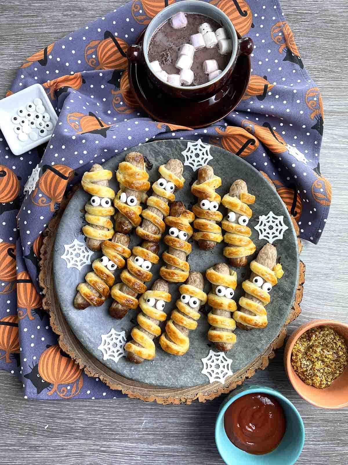 Halloween sausage rolls on a plate.