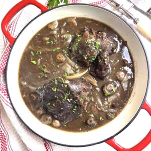 slow cooker beef cheeks in a casserole dish.