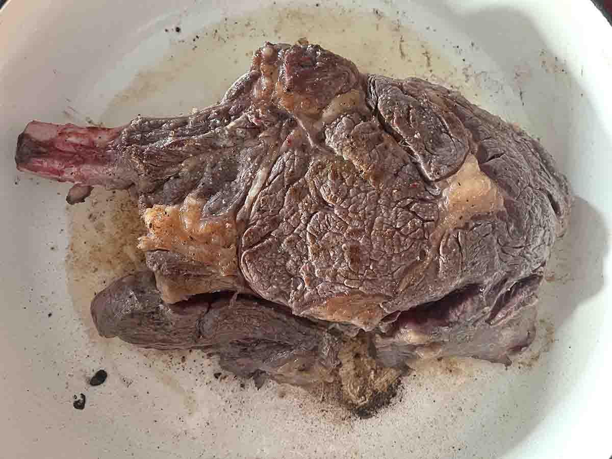 seared rib steak in a pan.