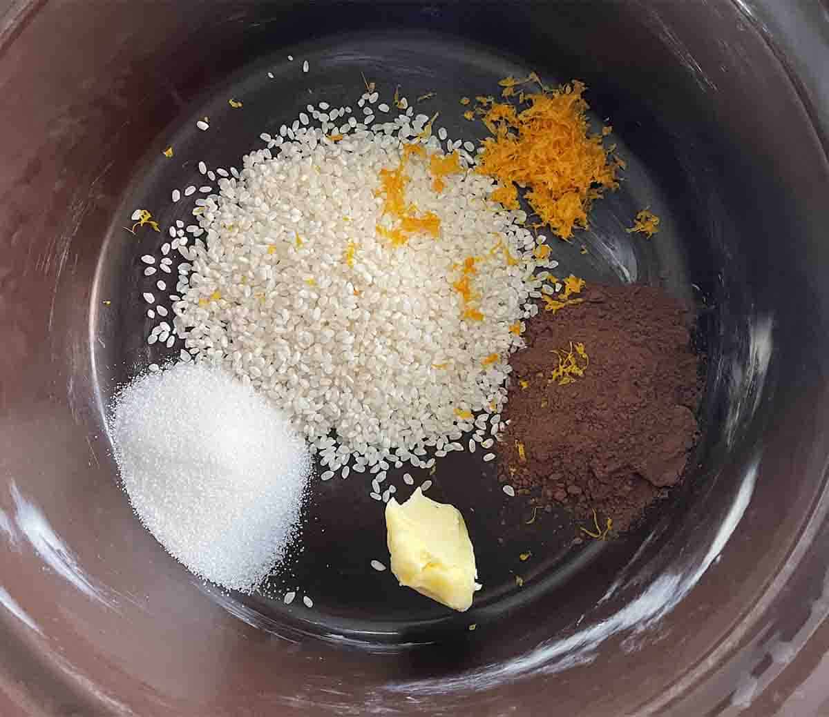 rice, zest, cocoa, sugar and butter in slow cooker.