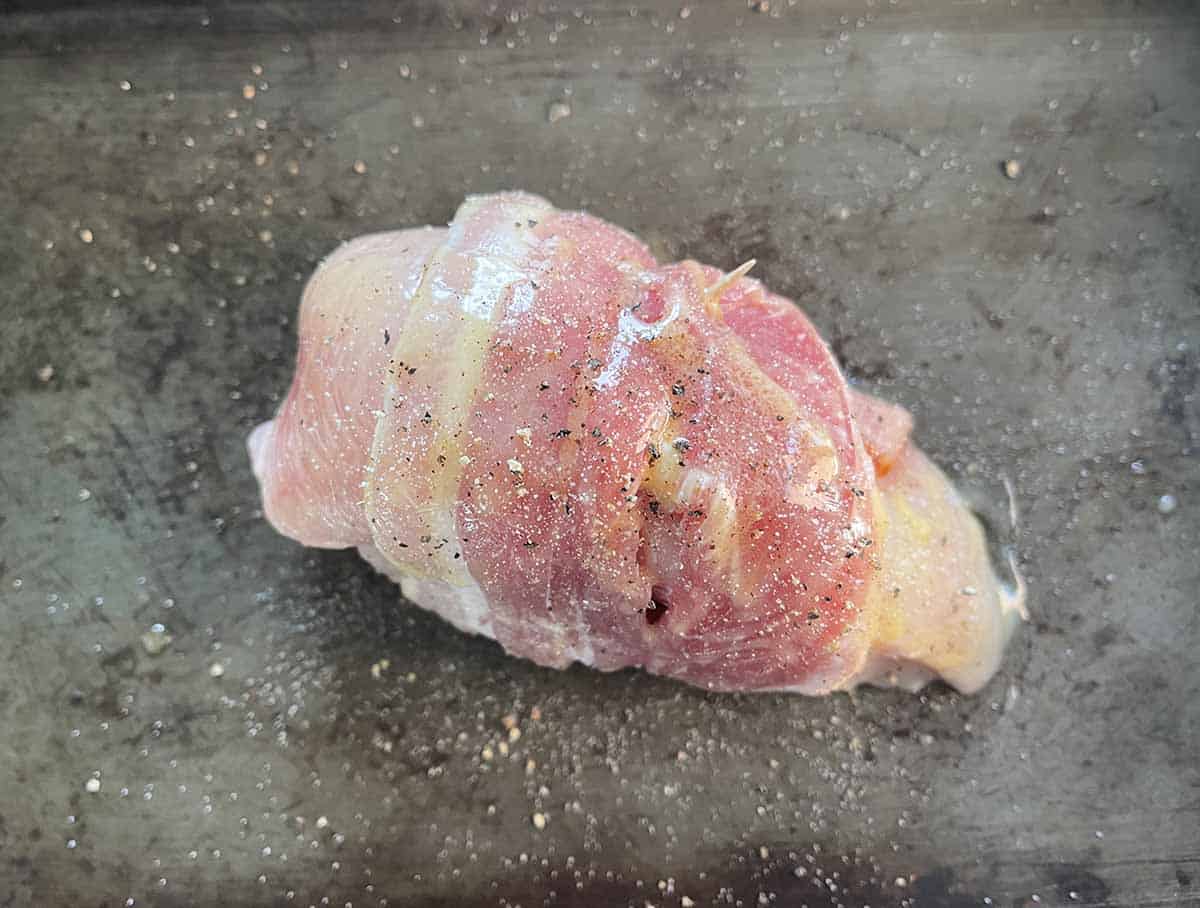 chicken covered in butter and seasoning.
