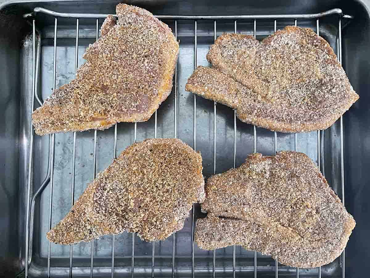 chops on a grill rack.