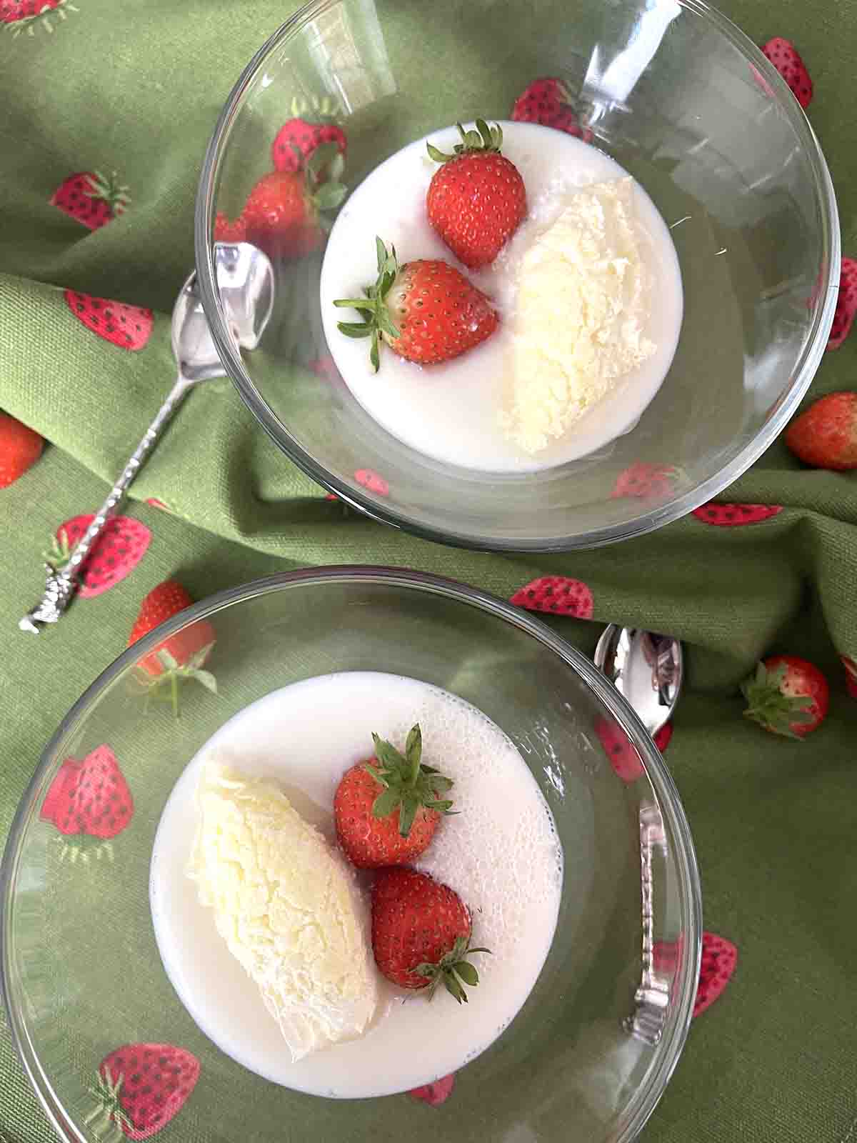 milk jelly garnished with strawberries and clotted cream.