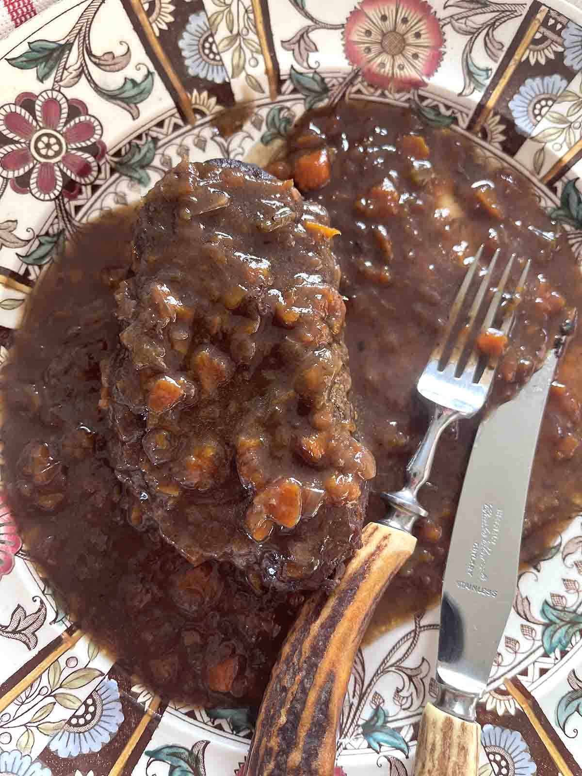 featherblade steak and gravy on a plate.