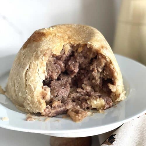 steak and kidney pudding with portion taken.