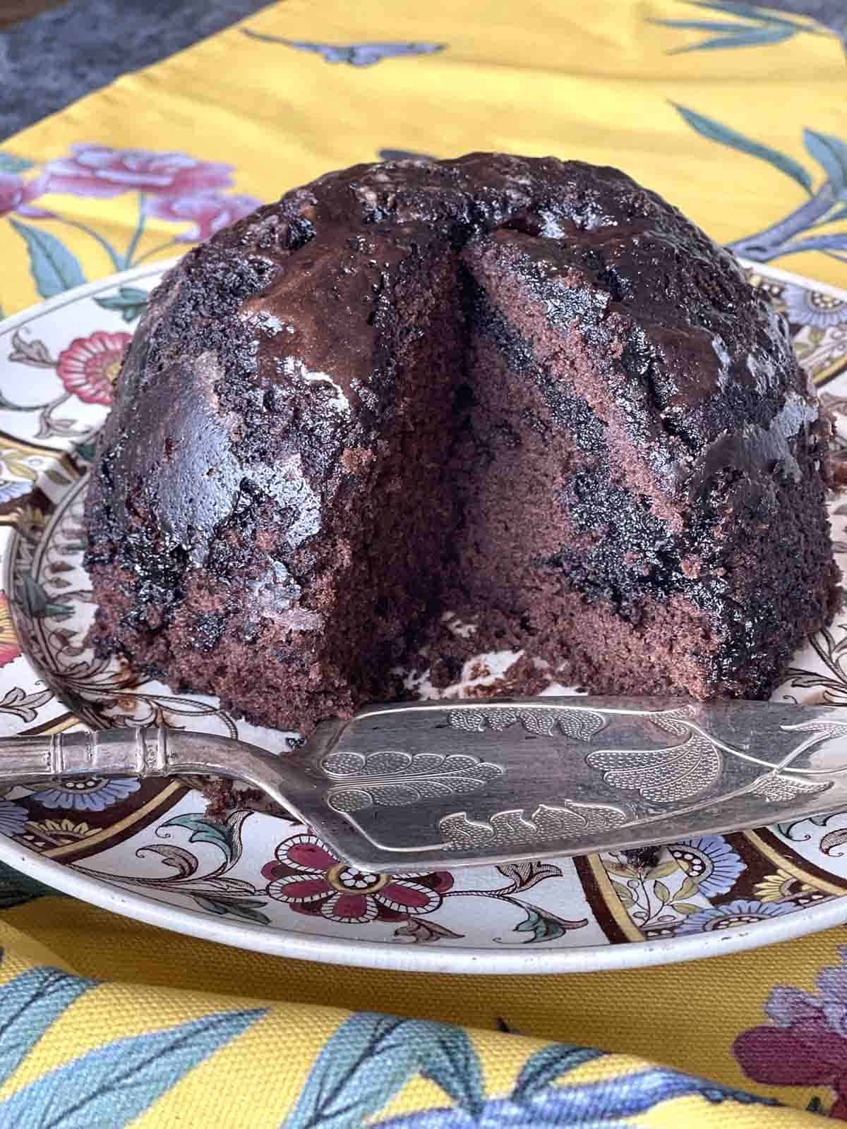 chocolate cake served with slice taken out.
