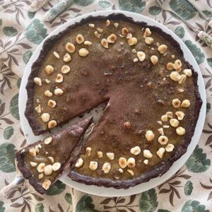 chocolate hazelnut tart on a plate.