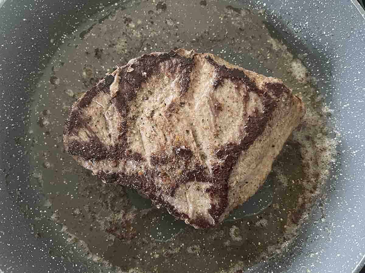 steak searing in a pan