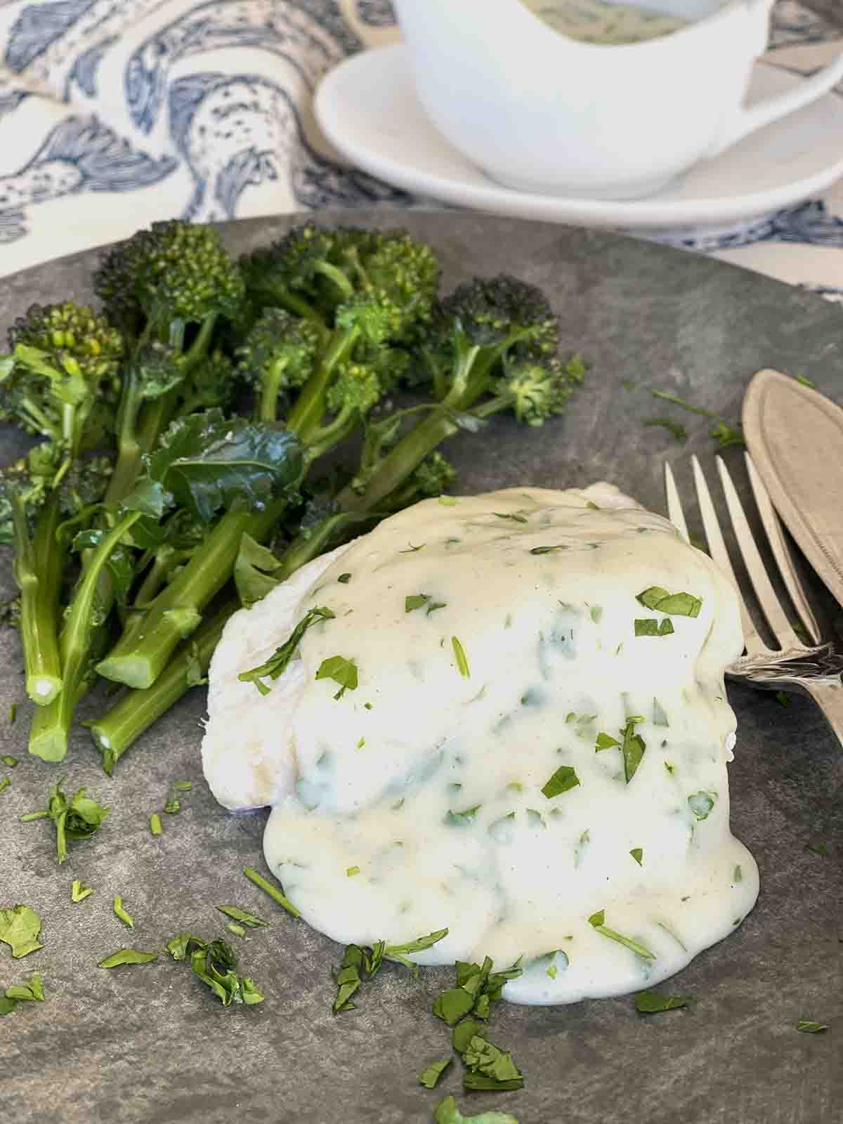 fish in parsley sauce on a plate.