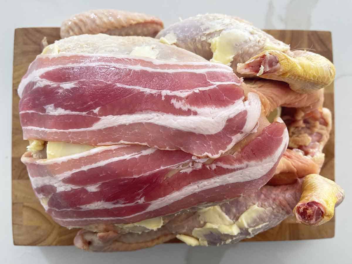 rooster covered with bacon.